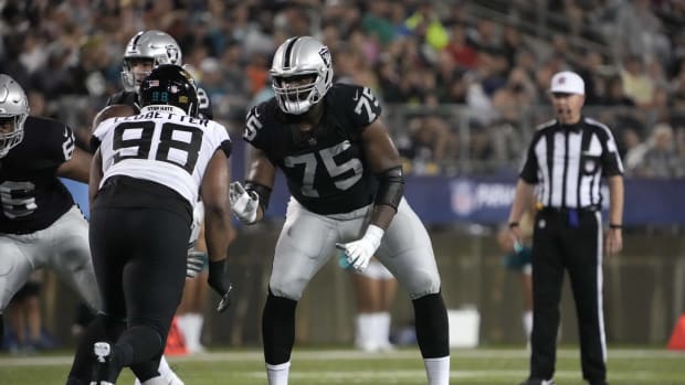 Aug 4, 2022; Canton, Ohio, USA; Las Vegas Raiders offensive tackle Brandon Parker (75) defends against Jacksonville Jaguars defensive end Jeremiah Ledbetter (98) in the Pro Football Hall of Fame game at Tom Benson Hall of Fame Stadium. Mandatory Credit: Kirby Lee-USA TODAY Sports  